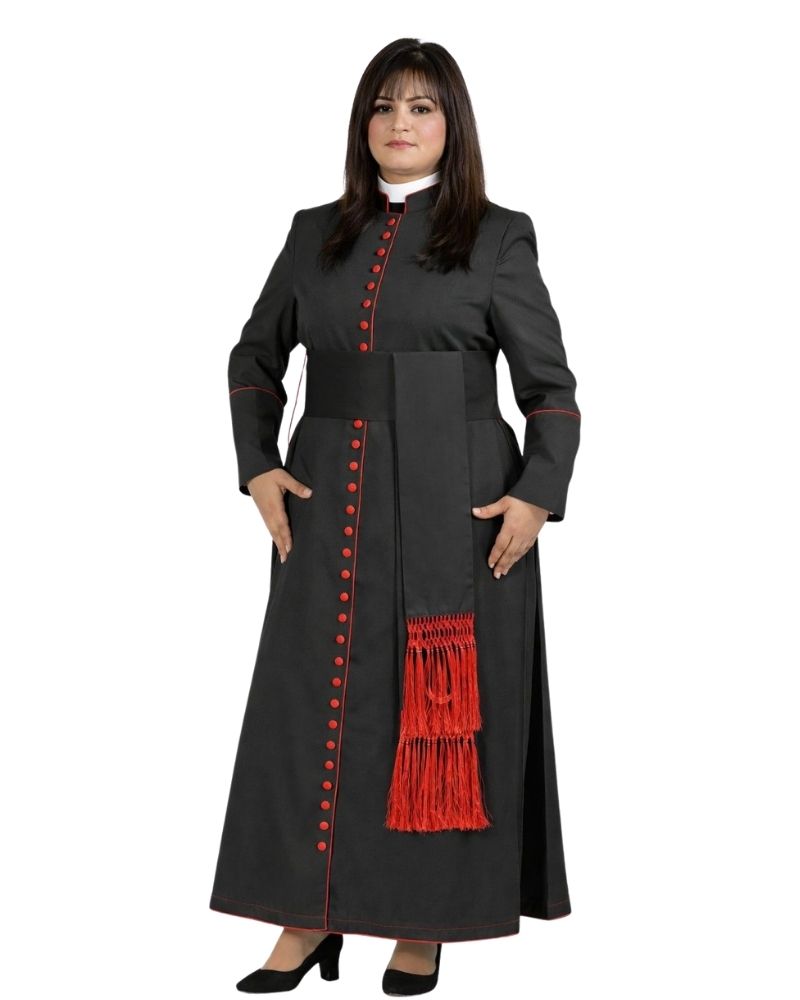 A woman modeling a long black cassock with red trim, red decorative buttons, and a red fringed detail on the front, set against a plain white background.