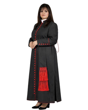 A woman modeling a long black clerical cassock with red trim, red decorative buttons, and a red tassel detail, shown against a plain white background.