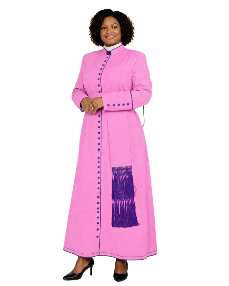 A woman modeling a long pink cassock with purple fringe and button details, set against a plain white background.