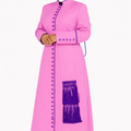 Woman wearing a pink robe with purple accents on a white background