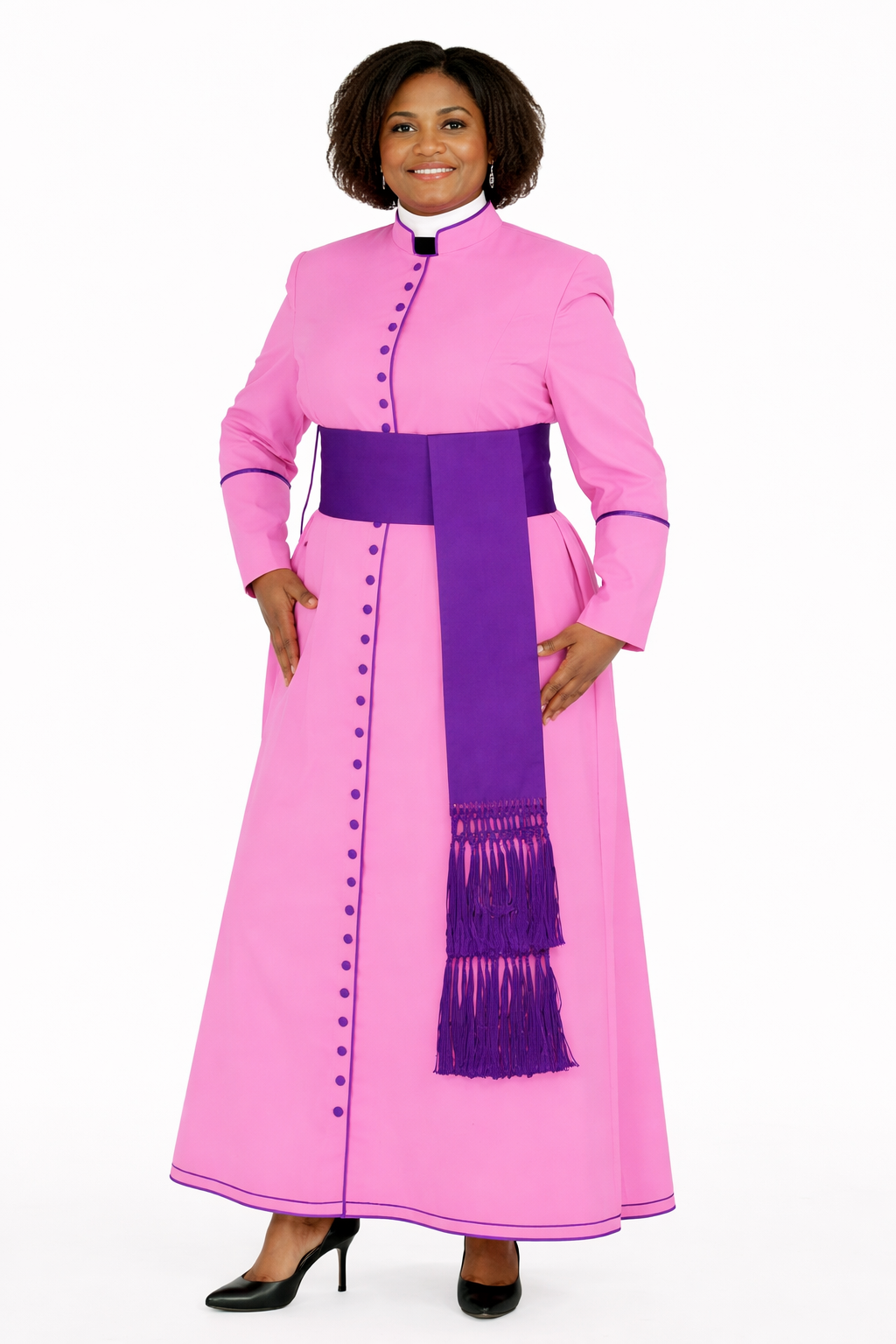 Women wearing a pink robe with a purple sash and stole on a white background