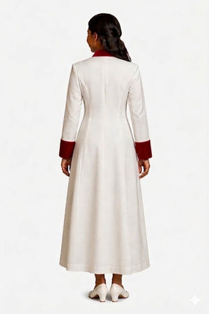 Woman wearing a long white robe with red cuffs and hem on a white background