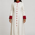 Woman wearing a long white robe with red cuffs on a white background