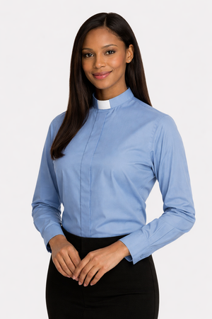Woman wearing a light blue clergy shirt with a white collar on a plain background