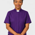 Women wearing a purple shirt with a white collar against a white background