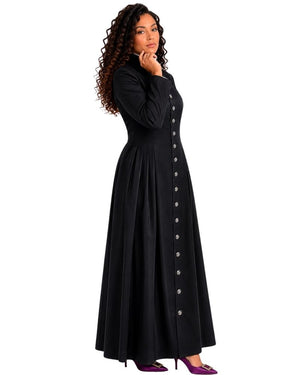 A woman modeling a long black cassock with a button-down front, shown in profile against a plain white background.