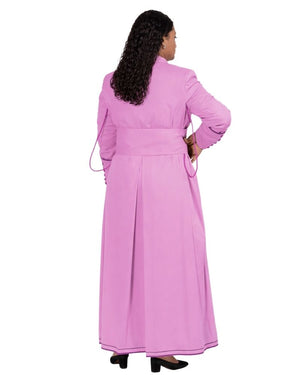 A woman shown from the back wearing a long pink cassock with a matching waist tie, photographed against a plain white background.