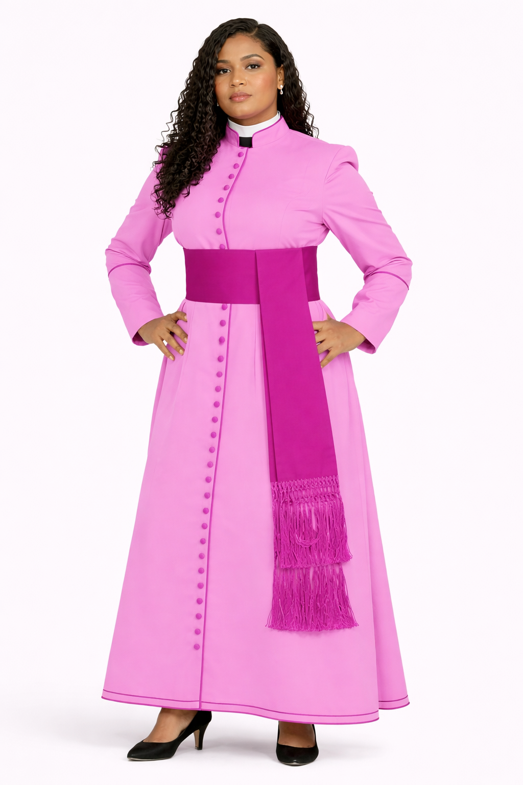 Woman wearing a pink traditional outfit with a belt and fringes on a white background