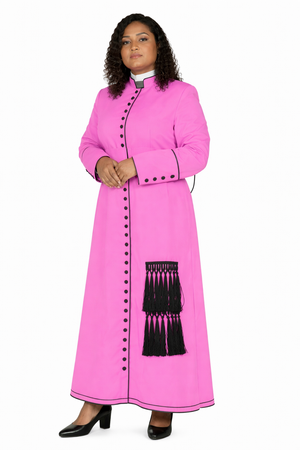 Woman wearing a bright pink robe with black buttons and tassels on a white background