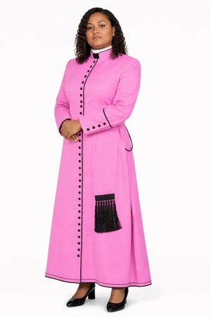 Woman wearing a pink robe with black buttons on a white background