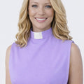 Woman wearing a purple top with a white collar against a white background
