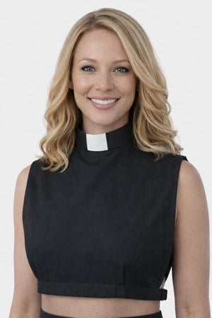 Woman wearing a black sleeveless top with a clerical collar against a white background