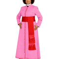 A woman modeling a pink cassock costume with a wide red waist sash and a red hanging scarf with fringe, against a plain white background.