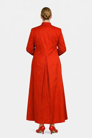 Woman wearing a red robe with buttons on a white background