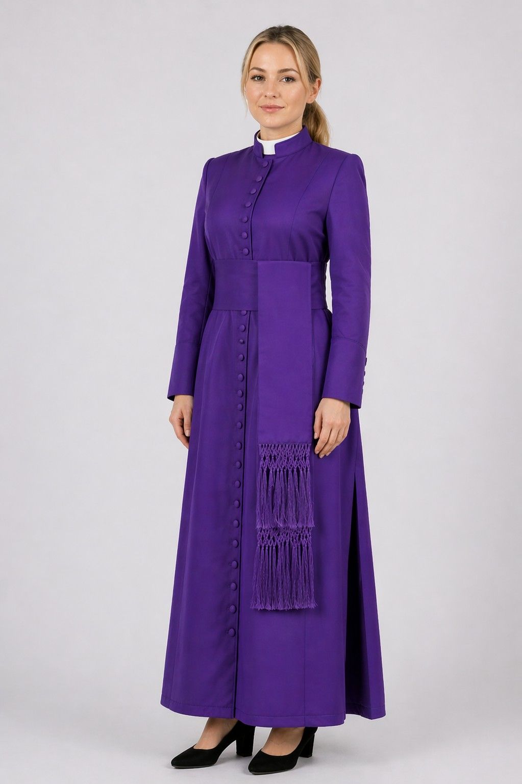 Woman wearing a long purple dress with a white collar on a white background