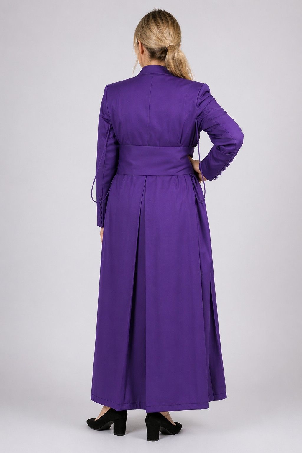 Purple coat worn by a person on a white background