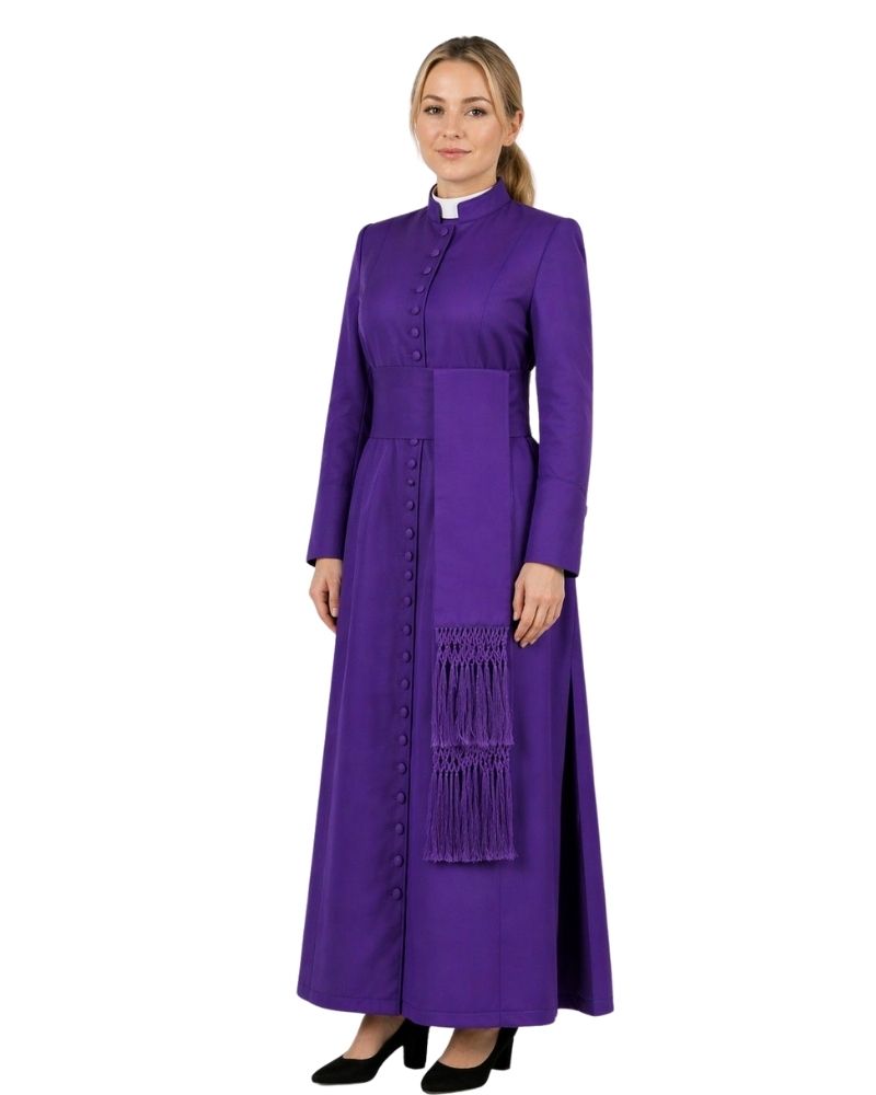 Woman wearing a long purple cassock with a white collar on a white background.