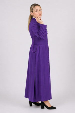 Woman wearing a long purple dress on a white background