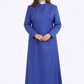 Woman wearing a long blue dress on a white background
