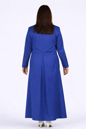 Woman wearing a long blue robe against a white background