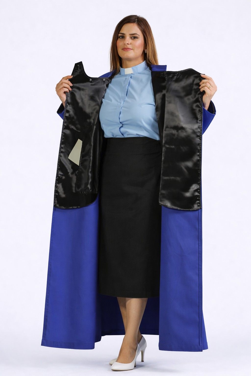 Woman holding a black and blue robe against a white background