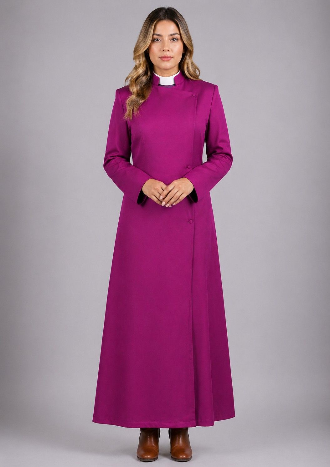 Woman wearing a long purple dress with a white collar against a gray background
