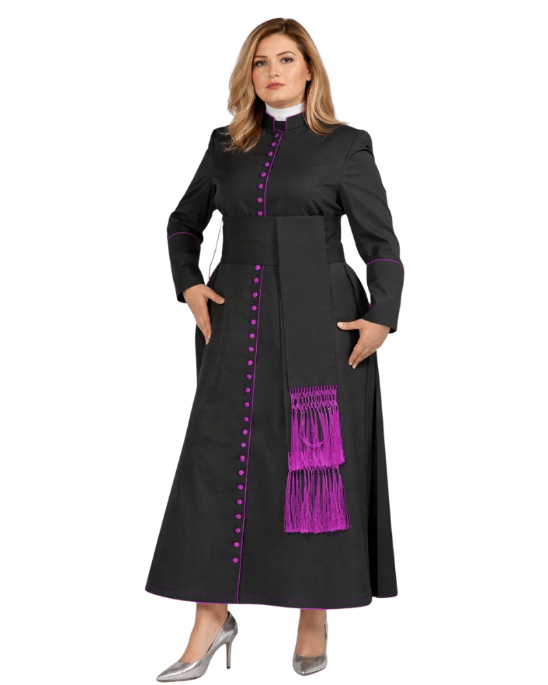 A woman modeling a long black clerical cassock with bright purple trim, button details, and a decorative purple fringe sash, paired with a white collar and silver heels, on a plain white background.
