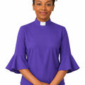 Woman wearing a purple shirt with ruffled sleeves on a white background