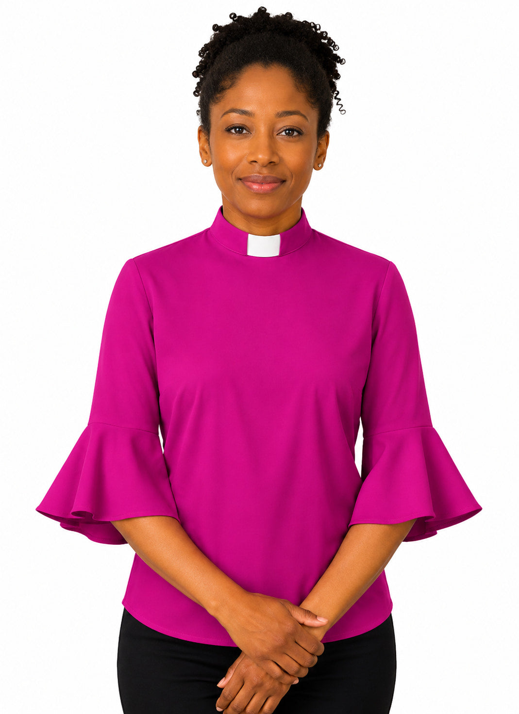Woman wearing a bright pink clergy shirt with a white collar on a white background