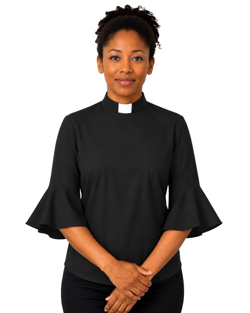 Woman wearing a  black clergy shirt with a white collar on a white background.