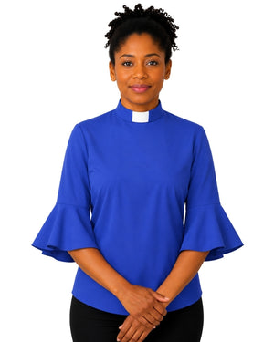 Woman wearing a blue clergy shirt with a white collar on a white background.