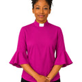 Woman wearing a bright pink clergy shirt with a white collar on a white background.