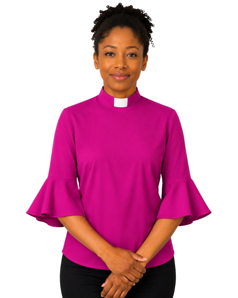 Woman wearing a bright pink clergy shirt with a white collar on a white background.