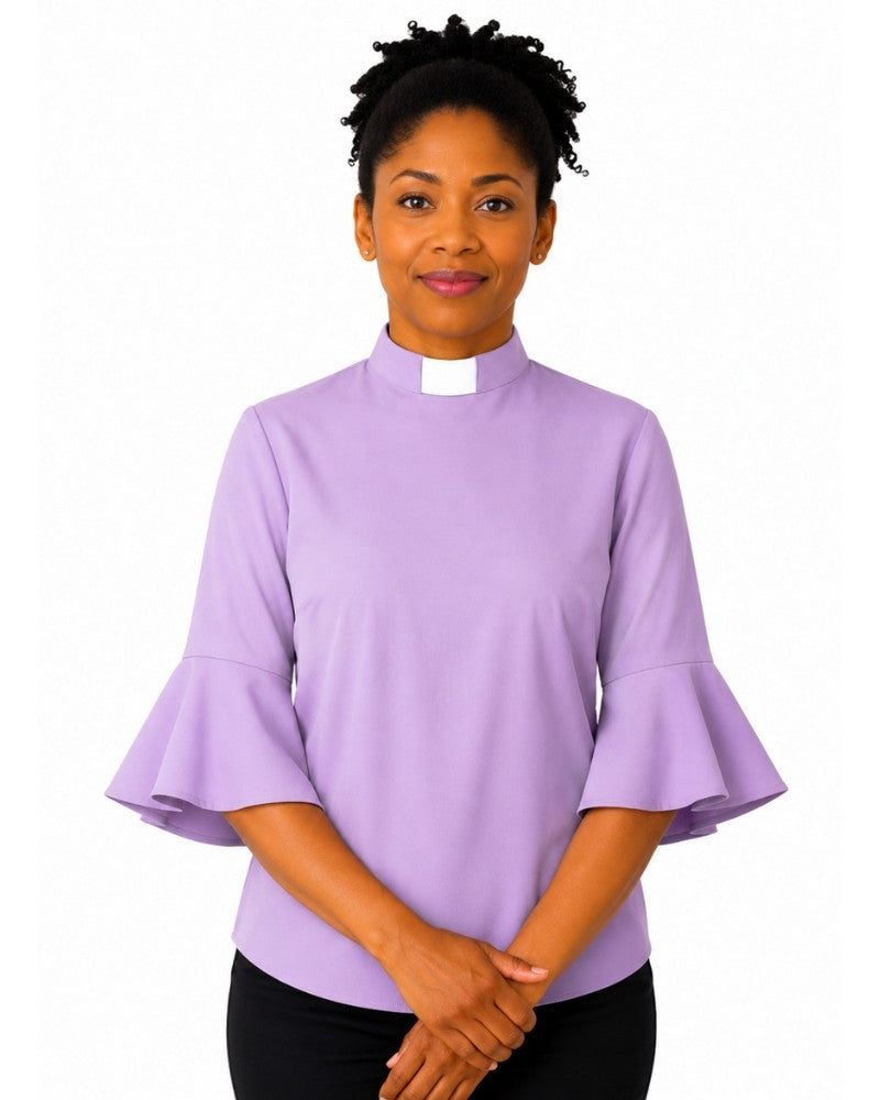 Woman wearing a light purple clergy shirt with a white collar on a white background.