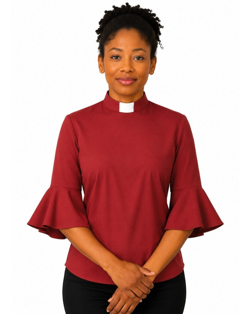 Woman wearing a redish  clergy shirt with a white collar on a white background.