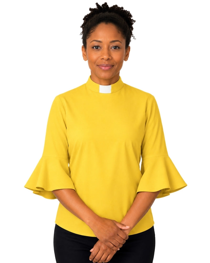 Woman wearing a yellow clergy shirt with a white collar on a white background.