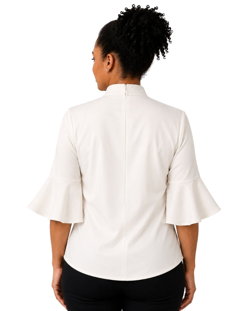 Woman wearing a offwhite clergy shirt with a white collar on a white background.