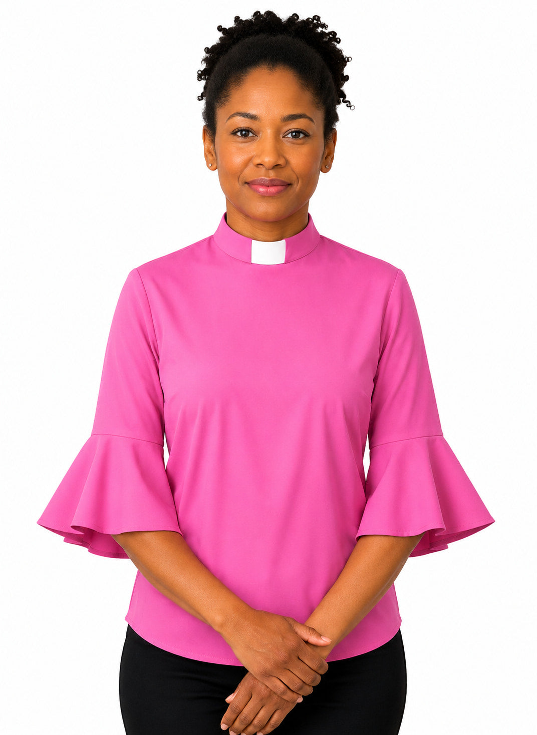 Woman wearing a pink shirt with ruffled sleeves on a white background
