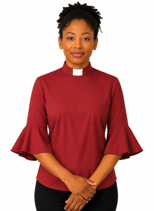 Woman wearing a redish shirt with ruffled sleeves on a white background
