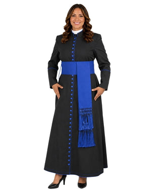 A woman modeling a long black dress with a bright blue sash and matching blue buttons, set against a plain white background.