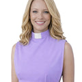 A smiling woman wearing a lavender sleeveless mock-neck top with a white clerical collar, shown against a plain white background.