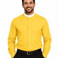 A smiling man wearing a bright yellow long-sleeve clerical shirt with a stand collar, paired with black trousers and a black belt, against a plain white background.