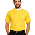 A smiling man wearing a bright yellow short-sleeve clerical shirt with a white collar, paired with black trousers and a black belt, against a plain white background.