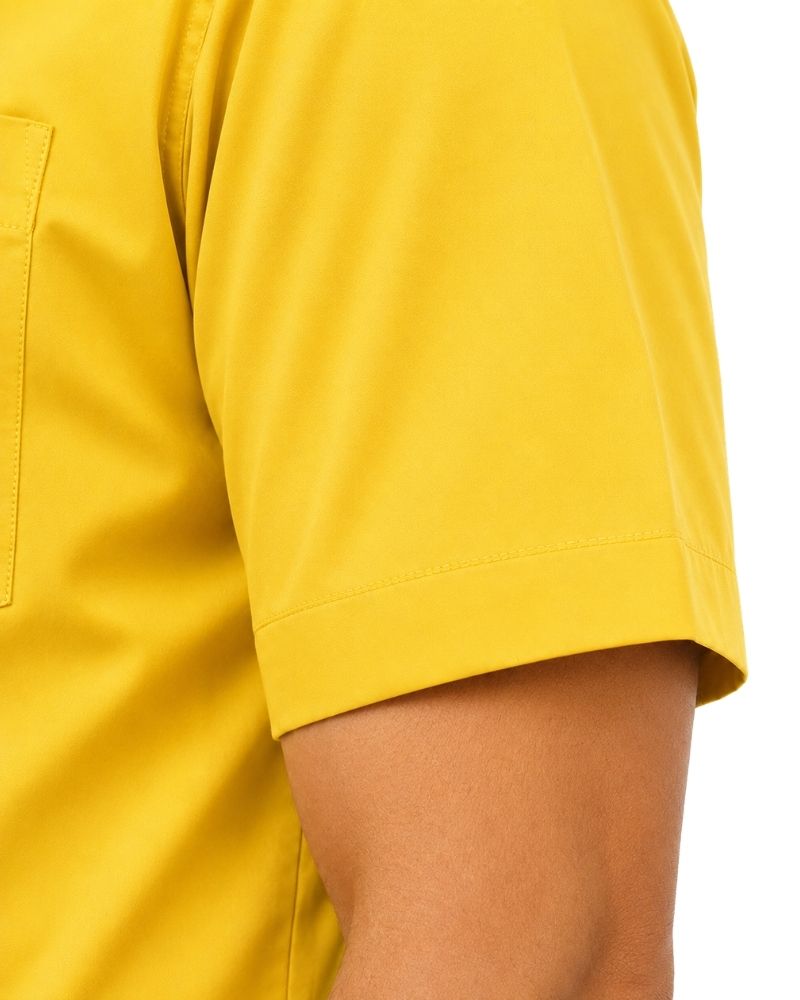 Close-up of a man wearing a bright yellow short-sleeve clerical shirt, showing the sleeve cuff and side pocket against a white background.
