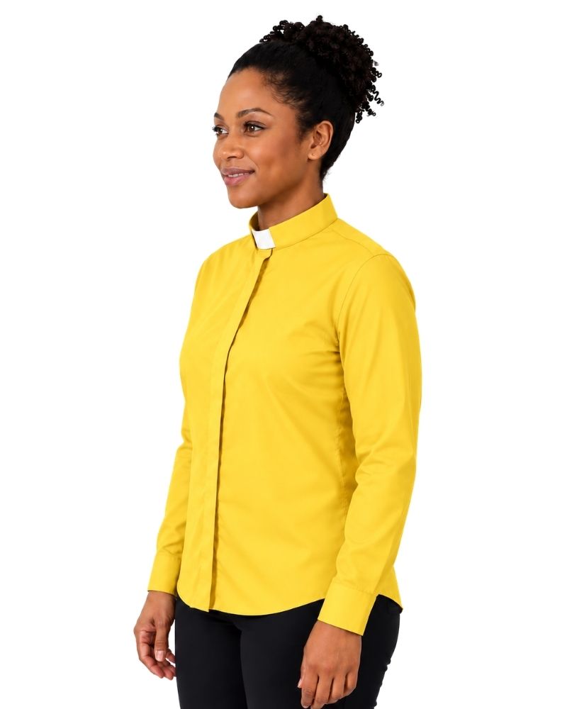 A woman wearing a bright yellow long-sleeve clerical shirt with a white collar, paired with black trousers, shown in profile against a plain white background.