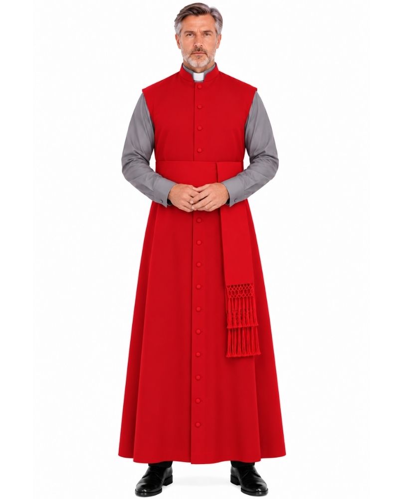 A man modeling a Zaccai Red Sleeveless Clergy Robe with a matching red cassock, worn over a gray long-sleeve shirt and black dress shoes, against a plain white background.