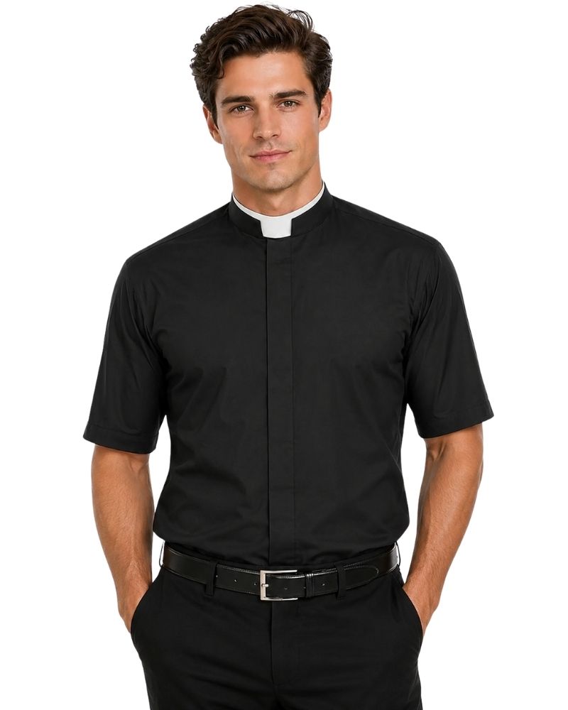 A man wearing a black short-sleeve clerical shirt with a white collar tab, paired with black trousers and a black belt, against a plain white background.
